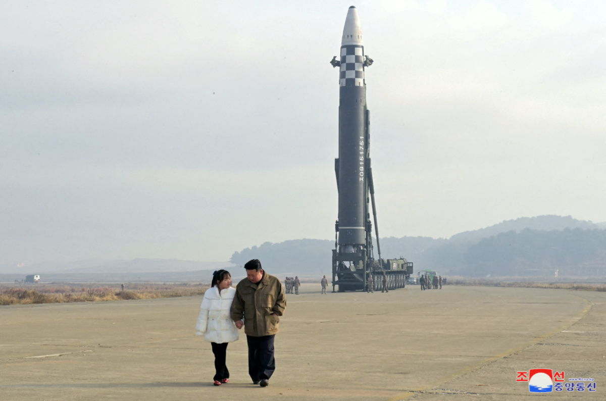 North Korean leader Kim Jong Un, along with his daughter, walks away from an intercontinental ballistic missile in this undated photo released on November 19, 2022 by North Korea's Korean Central News Agency