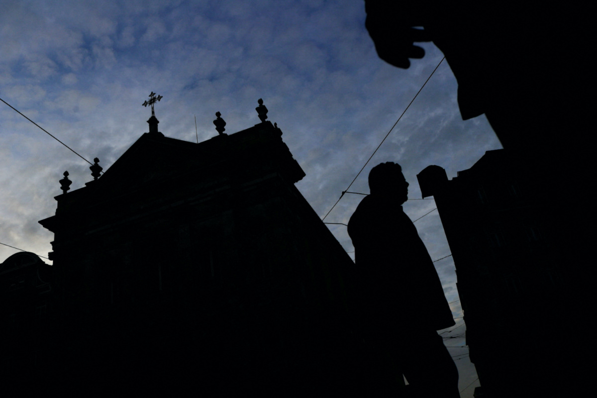 FILE PHOTO: People walk by a church on the day Portugal's commission investigating allegations of historical child sexual abuse by members of the Portuguese Catholic church will unveil its report, in Lisbon, Portugal, February 13, 2023. REUTERS/Pedro Nunes/File Photo