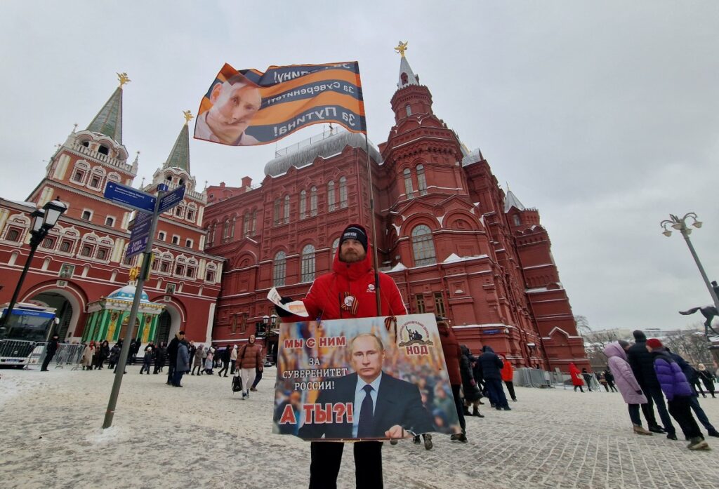 A supporter of Russian President Vladimir Putin distributes newspapers on the first anniversary of the beginning of Russia's military campaign in Ukraine, near the State Historical Museum in central Moscow, Russia, February 24, 2023. REUTERS/Shamil Zhumatov