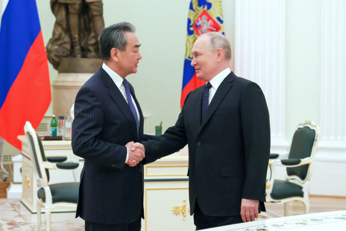 Russia's President Vladimir Putin shakes hands with China's Director of the Office of the Central Foreign Affairs Commission Wang Yi during a meeting in Moscow, Russia February 22, 2023. Sputnik/Anton Novoderezhkin/Pool via REUTERS