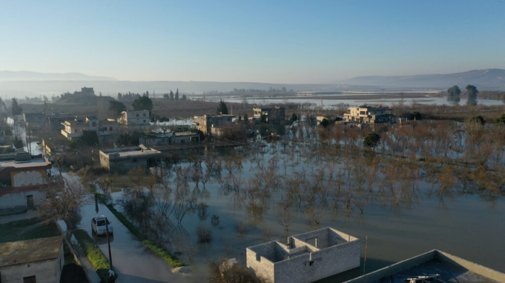 Village of Al-Tloul is flooded as a result of a Syrian dam being opened fearing aftershocks damaging the dam according to the Syrian Observatory of Human Rights, in Idlib region, Syria February 9, 2023 in this screen grab obtained from a social media video. Mohamed Al-Daher/via REUTERS.