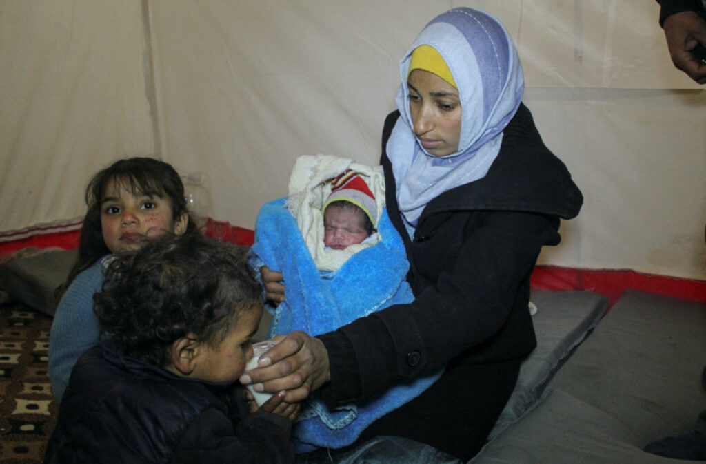 Fatmah Ahmad holds her new born baby Najm al-Din Mahmoud, who was born on the same day of the earthquake, in Aleppo, Syria February 10, 2023. REUTERS/Firas Makdesi