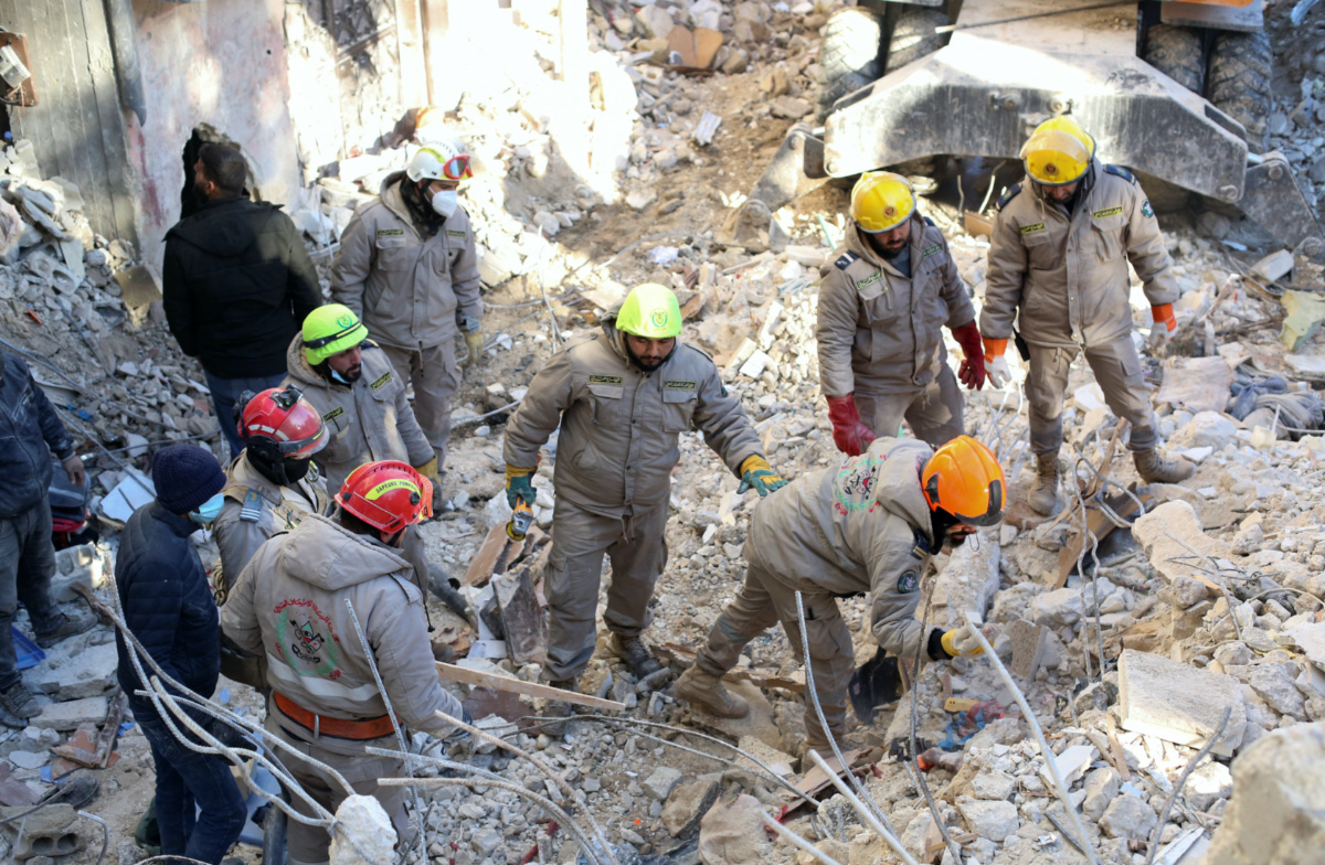 Rescuers search for survivors at the site of a collapsed building, in the aftermath of an earthquake, in Latakia, Syria February 9, 2023