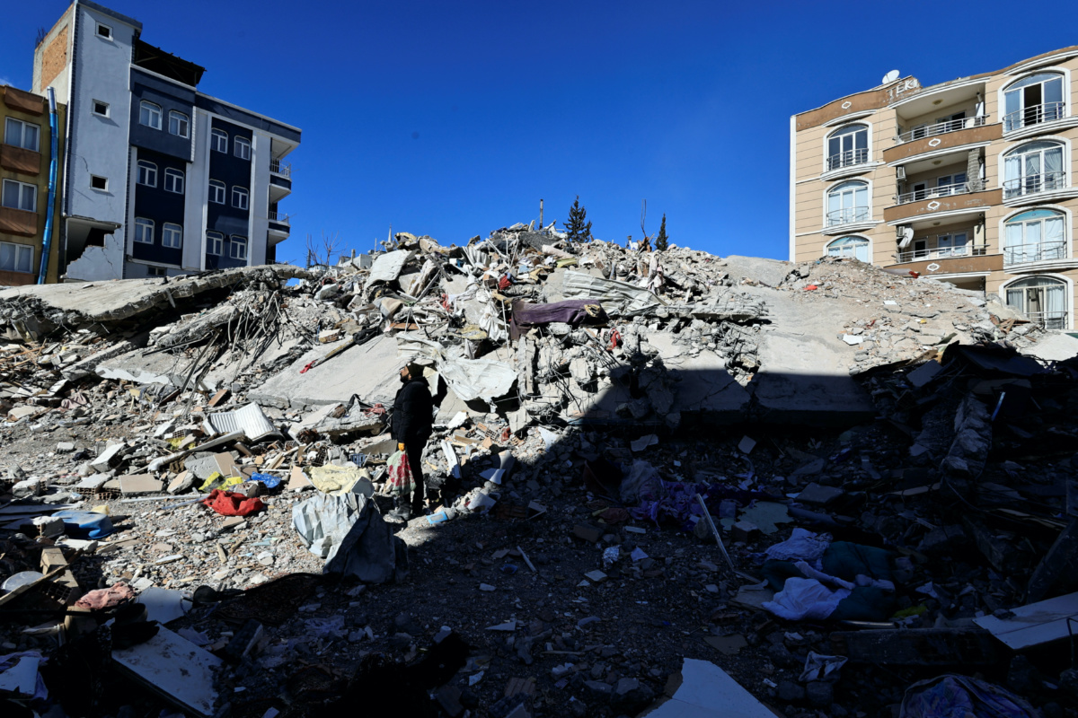 A man searches through the rubble for the remains of his belongings after his apartment was destroyed in the aftermath of a deadly earthquake in Adiyaman, Turkey February 16, 2023. 