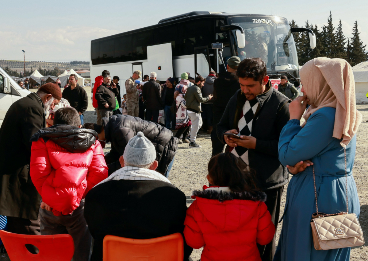 Families wait for the buses to transfer them to safe provinces after the latest earthquake hit in Antakya, Hatay province, Turkey, February 21, 2023. REUTERS/Thaier Al-Sudani