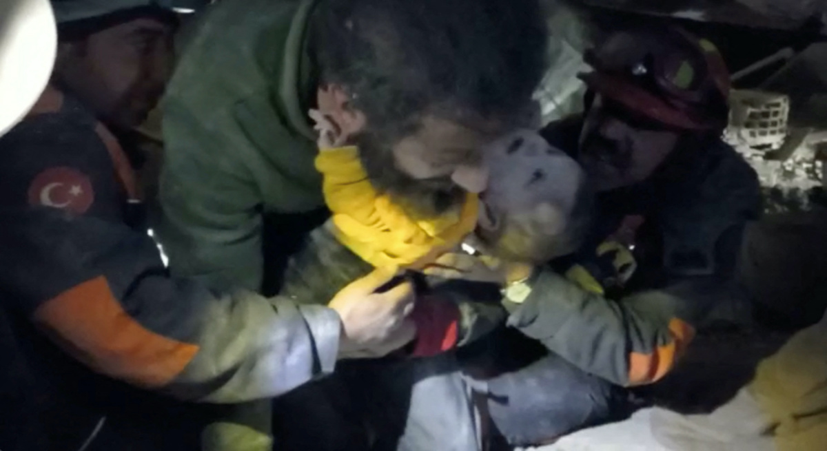 A baby is rescued from the rubble in the aftermath of a deadly earthquake in Hatay Province, Turkey, February 8, 2023 in this screen grab obtained from a handout video. Istanbul Municipality/Handout via REUTERS