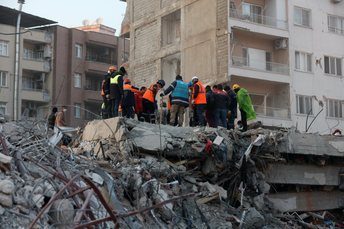 Members of a rescue team work on the site of a collapsed building, as the search for survivors continues, in the aftermath of a deadly earthquake, in Iskenderun, Turkey, February 11, 2023. 