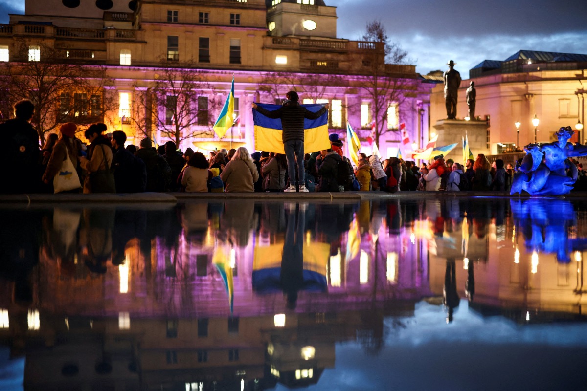 People attend a vigil for Ukraine held on the anniversary of the conflict with Russia, at Trafalgar Square in London, Britain February 23, 2023. REUTERS/Henry Nicholls