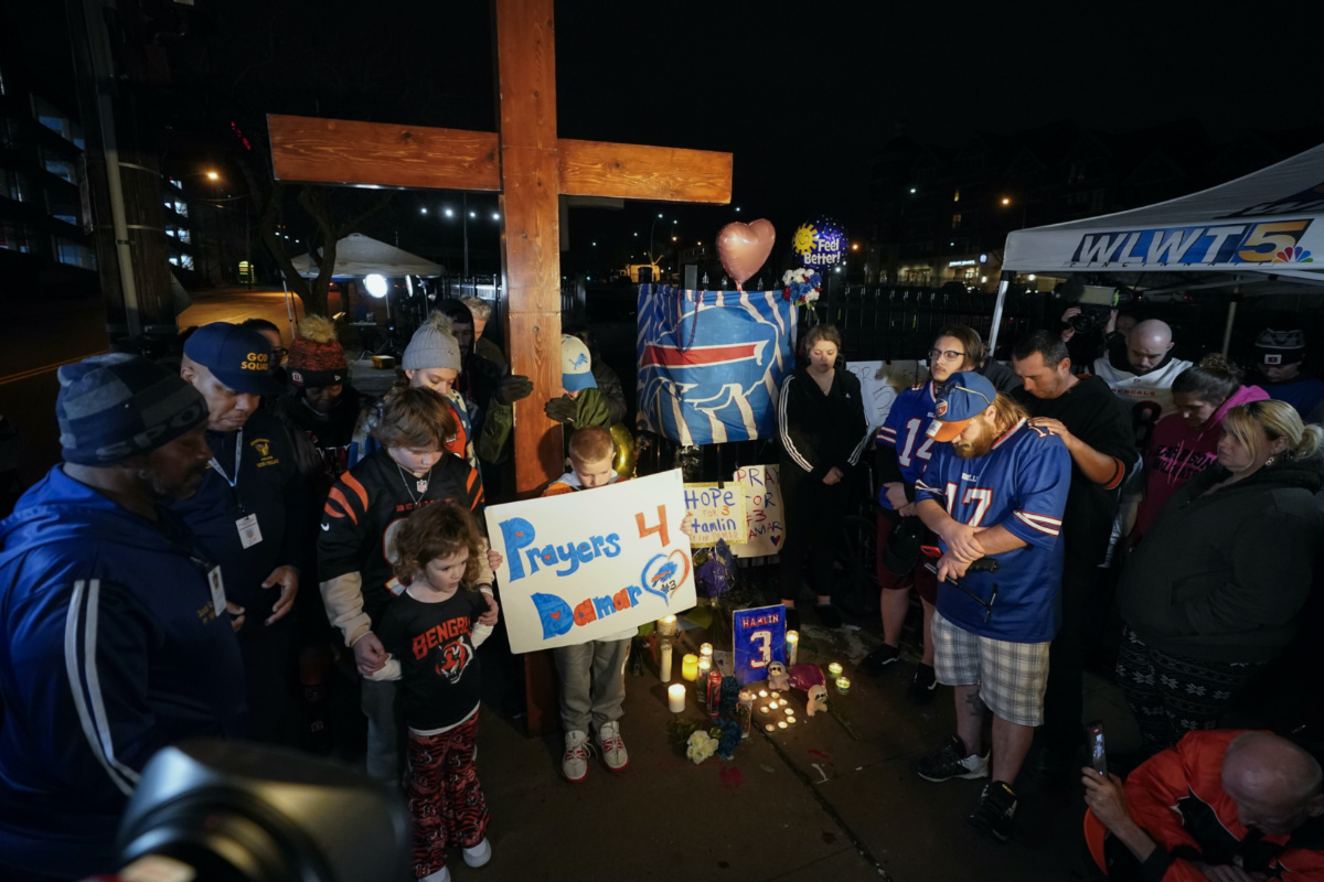 People pray during a prayer vigil for Buffalo Bills' Damar Hamlin outside of University of Cincinnati Medical Center, Tuesday, Jan. 3, 2023, in Cincinnati