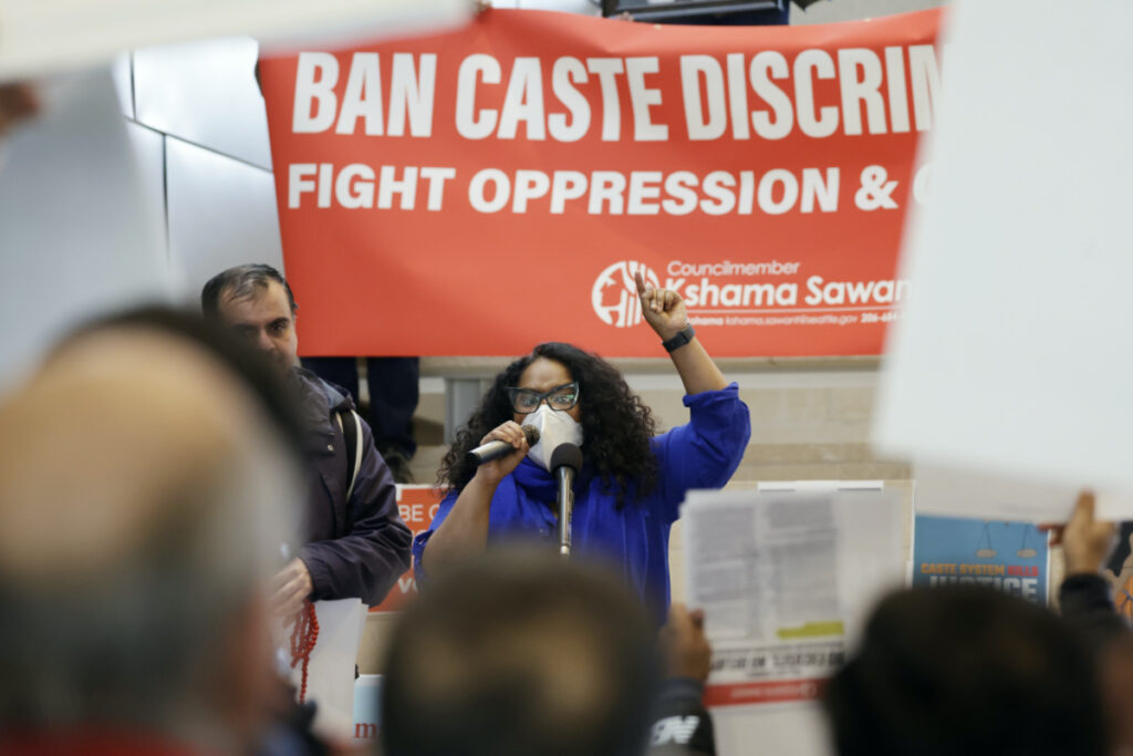Thenmozhi Soundararajan, founder and executive director of Equality Labs, speaks to supporters and opponents a of a proposed ordinance to add caste to Seattle’s anti-discrimination laws rally at Seattle City Hall, Tuesday, Feb. 21, 2023, in Seattle. Council Member Kshama Sawant proposed the ordinance. (AP Photo/John Froschaue