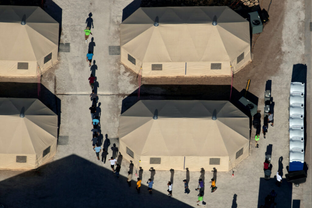 FILE PHOTO: Immigrant children are led by staff in single file between tents at a detention facility next to the Mexican border in Tornillo, Texas, U.S., June 18, 2018. REUTERS/Mike Blake