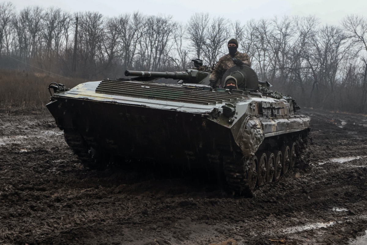 Ukrainian service members ride inside an infantry fighting vehicle near the frontline town of Bakhmut, amid Russia's attack on Ukraine, in Donetsk region, Ukraine February 25, 2023.
