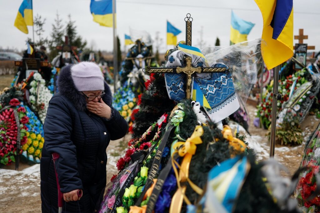 Mariia reacts near the grave of her son Vasyl Kurbet, Ukrainian service member killed in a fight against Russian troops, on a day of the first anniversary of Russia's attack on Ukraine, at a cemetery in the town of Bucha, outside Kyiv, Ukraine February 24, 2023. REUTERS/Valentyn Ogirenko