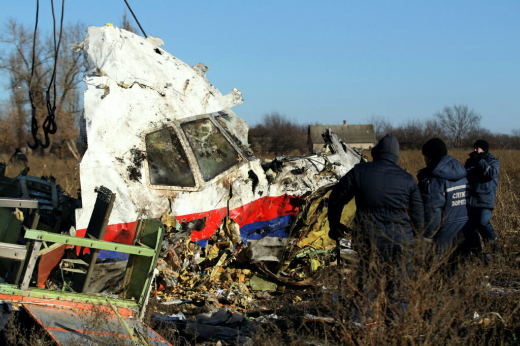 Local workers transport a piece of wreckage from Malaysia Airlines flight MH17 at the site of the plane crash near the village of Hrabove (Grabovo) in Donetsk region, eastern Ukraine November 20, 2014.