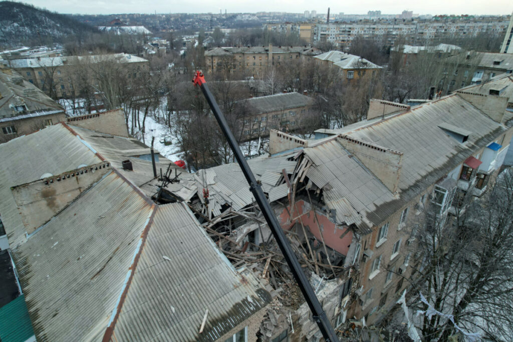 Rescuers use a crane to remove debris of a multistorey residential building damaged in recent shelling in the course of Russia-Ukraine conflict in Donetsk, Russian-controlled Ukraine, February 4, 2023. REUTERS/Pavel Klimov