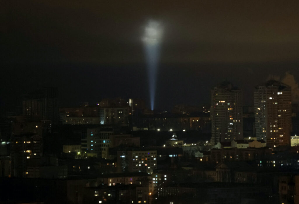 Ukrainian servicemen use a searchlight as they search for drones in the sky over the city during a Russian drone strike, amid Russia's attack on Ukraine, in Kyiv, Ukraine February 27, 2023.