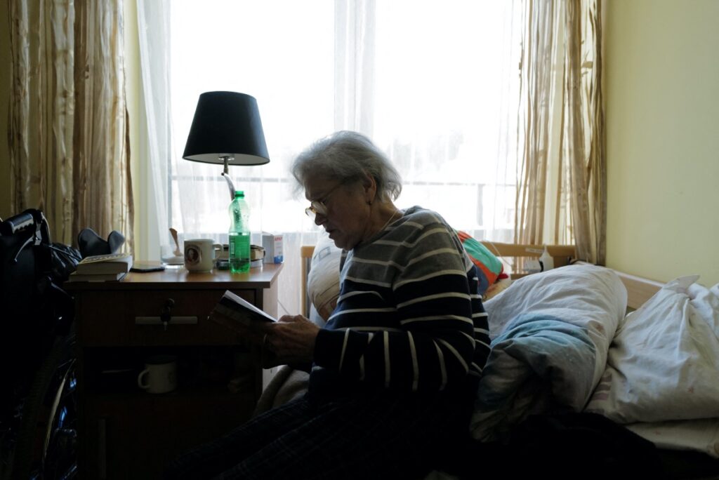 Ukrainian refugee Tamila Melnichenko, 82, from Kyiv, reads a book in her room at the Armada retirement home in Glogoczow, Poland February 10, 2023.