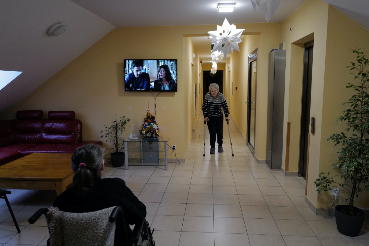 Ukrainian refugee Tamila Melnichenko, 82, from Kyiv, walks with crutches to the communal living room at the Armada retirement home in Glogoczow, Poland February 2, 2023. A year ago, she was uprooted by the Russian invasion and now spends her days in the retirement home, longing for the life she had to leave behind. The former nurse reads Ukrainian and Russian classics and memorises poems or walks down the narrow corridors on her crutches to keep herself busy as the days slowly tick by. Her thoughts constantly drift back to Ukraine where she lived all her life and raised her family. "I'm old, I want to die there (in Kyiv). Now I don’t know where I will die," she said. REUTERS/Kacper Pempel.