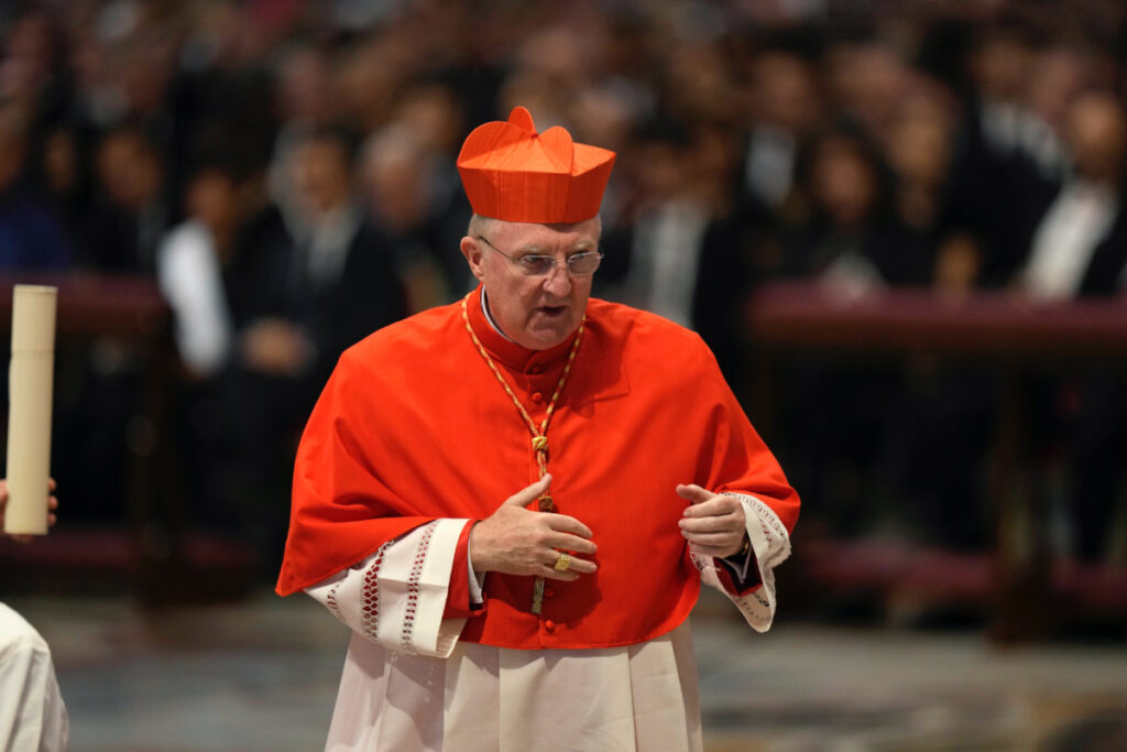 Cardinal Arthur Roche walks after receiving the red three-cornered biretta hat from Pope Francis during a consistory inside St. Peter's Basilica, at the Vatican, on Aug. 27, 2022.