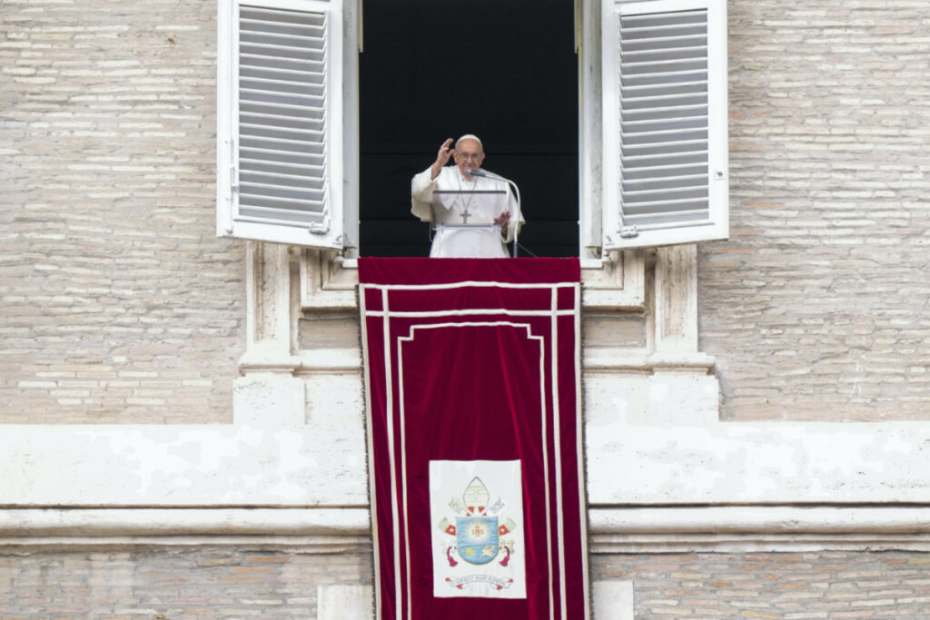 Pope Francis delivers his blessing as he recites the Angelus noon prayer from the window of his studio overlooking St Peter's Square, at the Vatican, Sunday, Feb. 26, 2023.