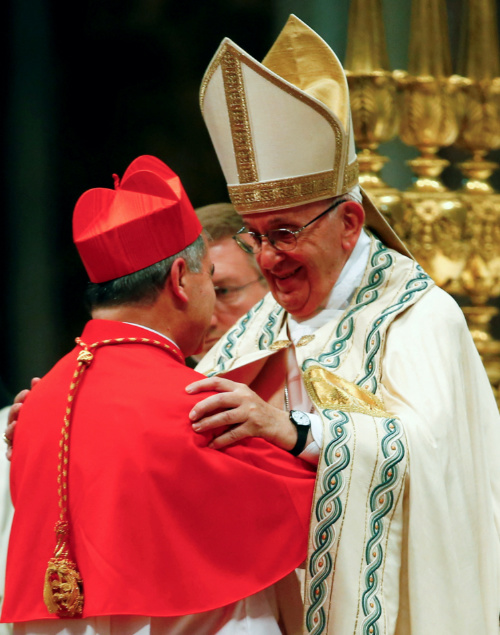 Pope Francis blesses new cardinal Giovanni Angelo Becciu of Italy during a consistory ceremony to install 14 new cardinals in Saint Peter's Basilica at the Vatican, June 28 2018.