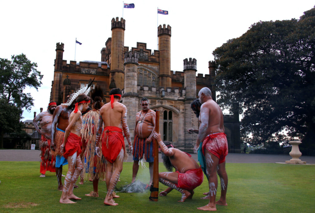 FILE PHOTO: Australian Aborigines and Torres Strait Islanders wearing traditional dress stand in front of Government House after performing in a welcoming ceremony in Sydney, Australia, June 28, 2017. REUTERS/David Gray/File Photo