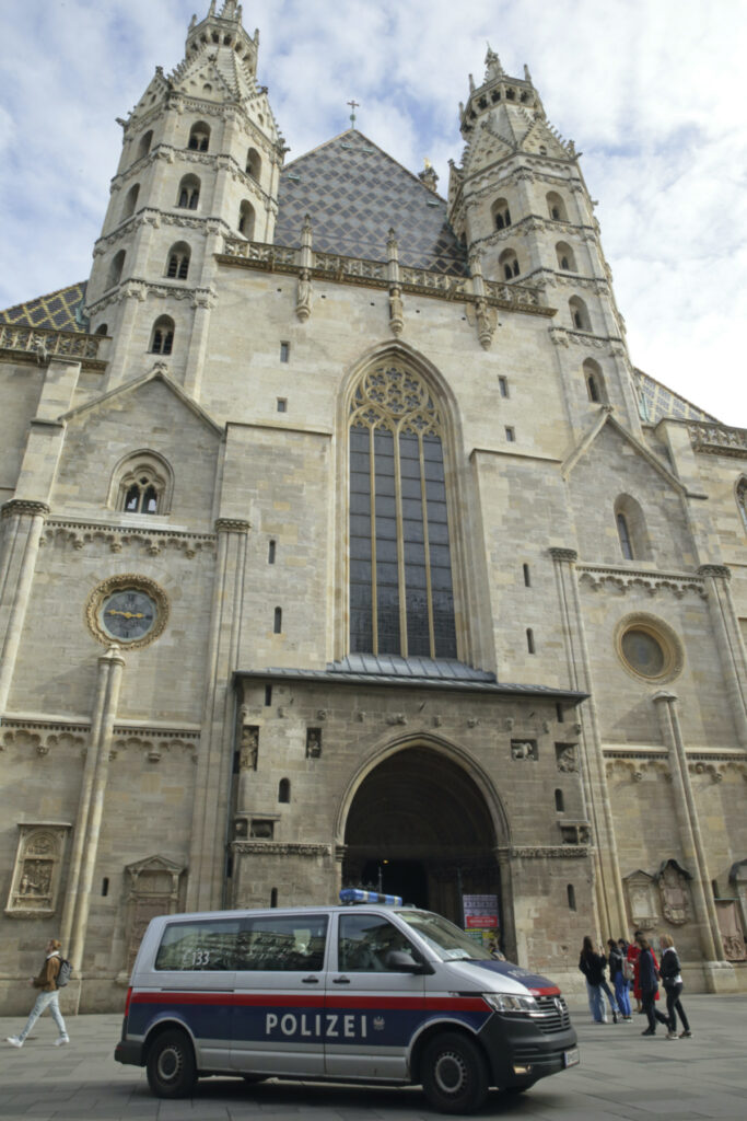A police van drives past St. Stephen's cathedral in Vienna, Austria, Wednesday, Mar 15, 2023. Austrian police are warning of a possible “Islamist-motivated attack” targeting churches in Vienna. They cited undisclosed information the country’s intelligence service had received. (AP Photo/Heinz-Peter