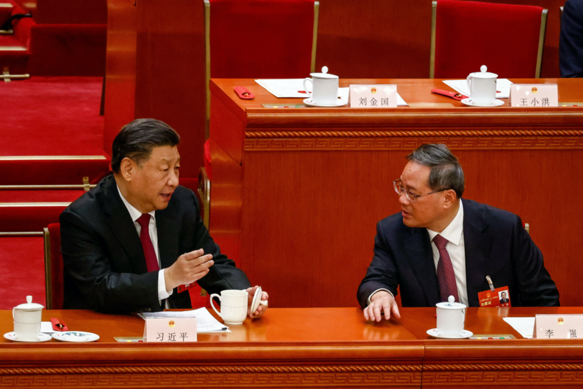 Chinese President Xi Jinping talks to Li Qiang during the Third Plenary Session of the National People's Congress at the Great Hall of the People, in Beijing, China, 10 March 2023. 