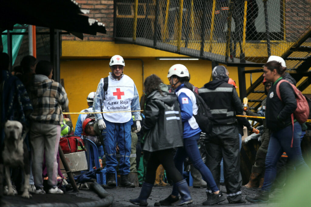 People wait during the search and rescue work of miners trapped following the explosion of a mine in Sutatausa, Colombia, March 15, 2023.