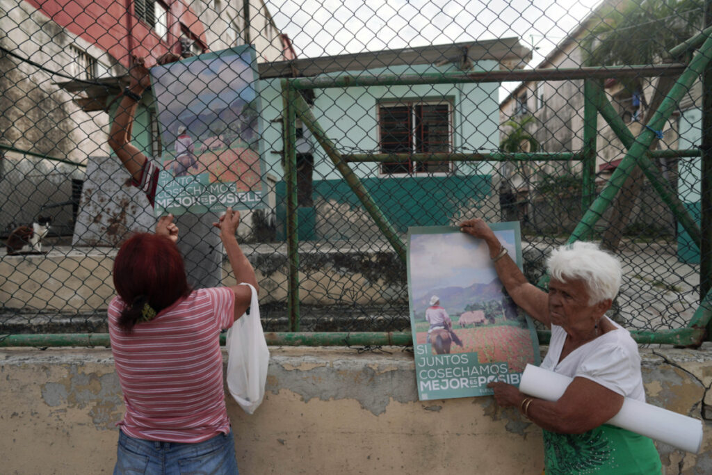 People hang signs announcing the upcoming legislative elections in Havana, Cuba, March 25, 2023. REUTERS/Alexandre Meneghini