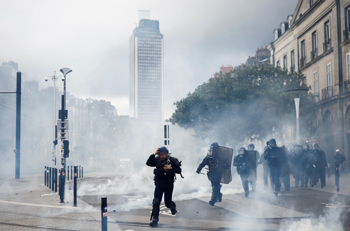French gendarmes disperse protesters during a demonstration against the use by French government of the article 49.3, a special clause in the French Constitution, to push the pensions reform bill through the National Assembly without a vote by lawmakers, in Nantes, France, on 18th March, 2023