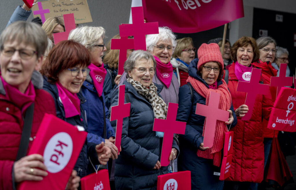 Members of the KFD group, which represents Catholic women in Germany protest prior to the beginning of the Fifth Synodal Meeting in Frankfurt, Germany, Thursday, March 9, 2023. They demand equal rights for women in the Catholic Church. (AP Photo/Michael Probst)