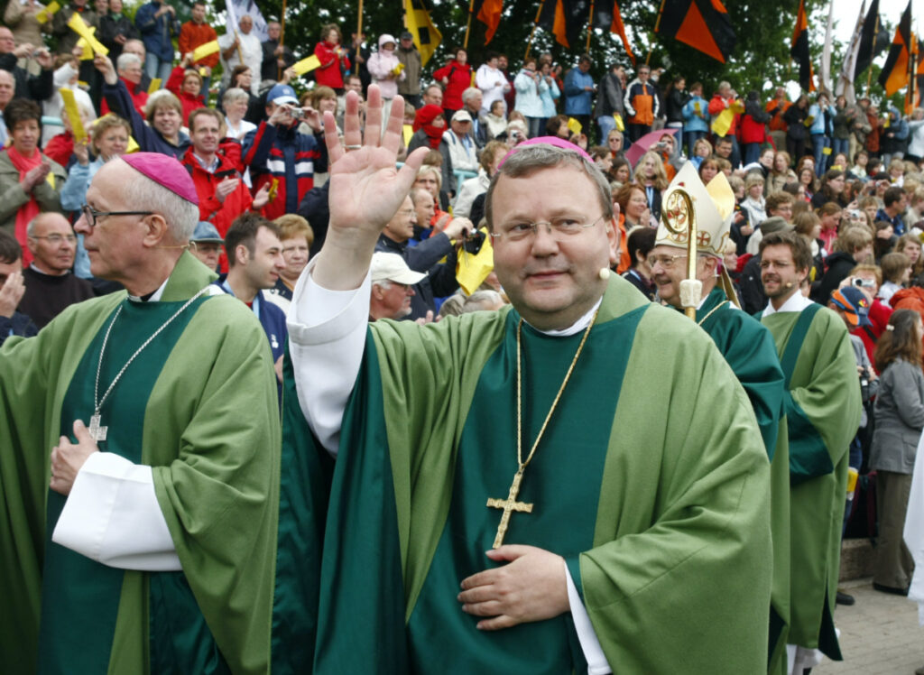 FILE - In this May 25, 2008, file photo, Bishop Franz-Josef Bode waves during the closing service of the 97th German Catholics Day in Osnabrueck, northern Germany. Pope Francis on Saturday, March 25, 2023 accepted a resignation request from a German bishop who asked to step down because of his mistakes in handling sexual abuse cases.  Franz-Josef Bode became the bishop of Osnabrueck, Germany, in 1995. (AP Photo/Joerg Sarbach, File