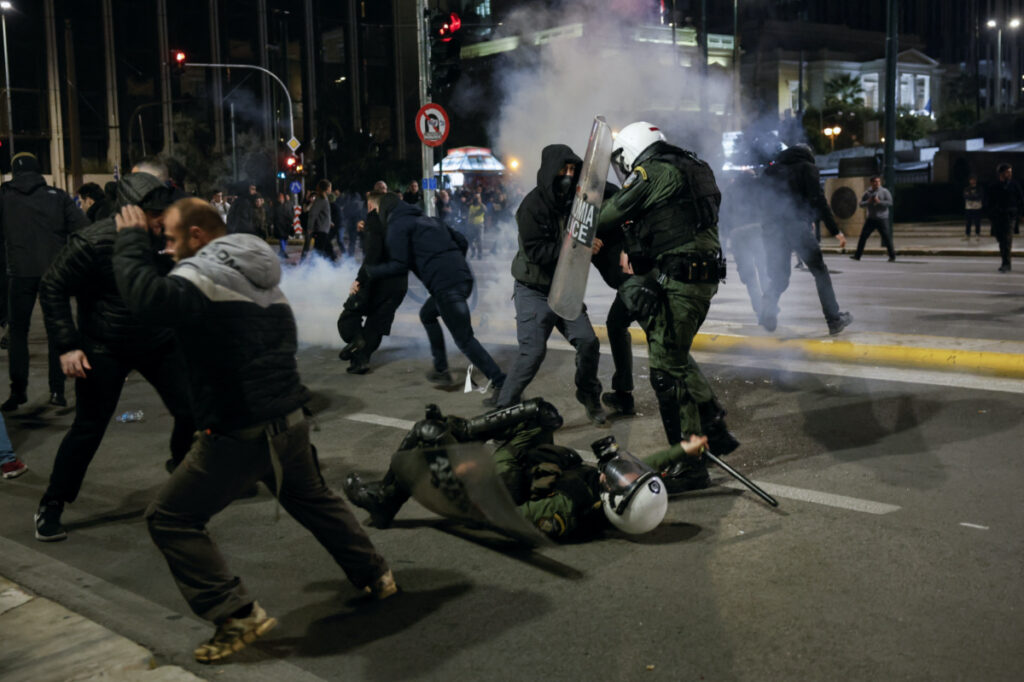 Protesters attack riot police officers as clashes take place during a demonstration in front of the parliament building following the collision of two trains, near the city of Larissa, in Athens, Greece, March 3, 2023.