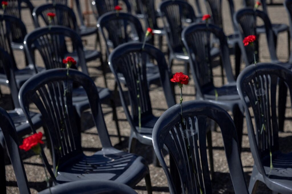 Carnations are placed on fifty-seven chairs, representing the victims of a fatal train collision near the city of Larissa, during a demonstration outside the Transport Ministry in Athens, Greece, March 6, 2023.