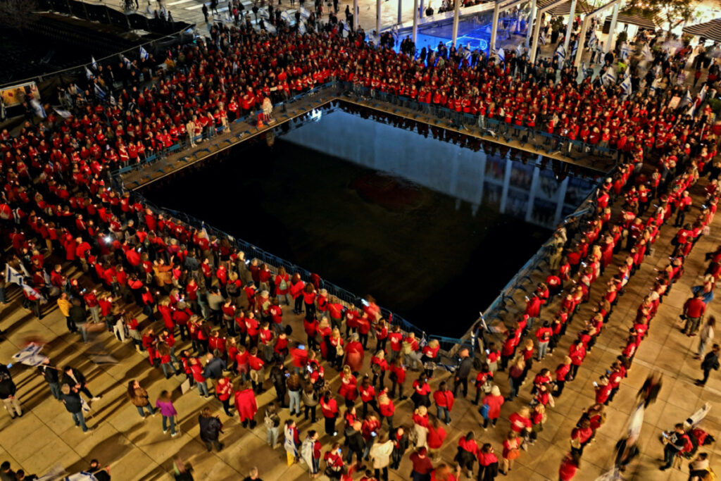 An aerial view shows women wearing red clothes during a demonstration as Israeli Prime Minister Benjamin Netanyahu's nationalist coalition government presses on with its contentious judicial overhaul, in Tel Aviv, Israel, on 18th March, 2023.
