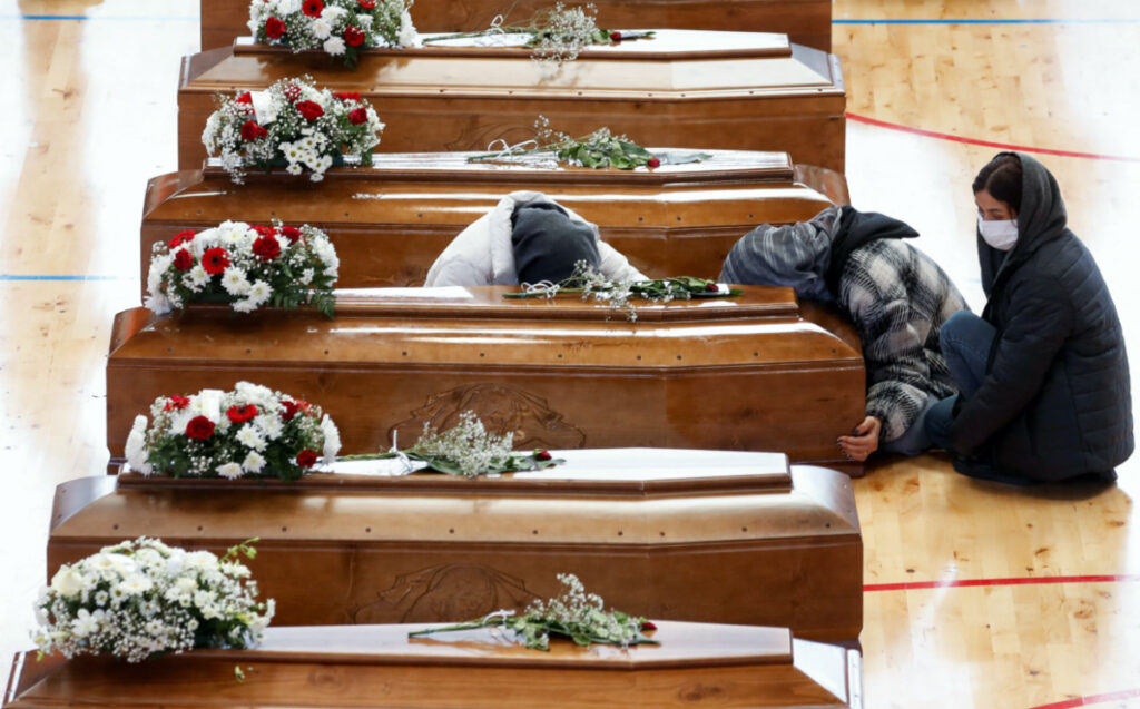Mourners react near coffins of victims who died in a migrant shipwreck, in Crotone, Italy March 1, 2023. REUTERS/Remo Casilli