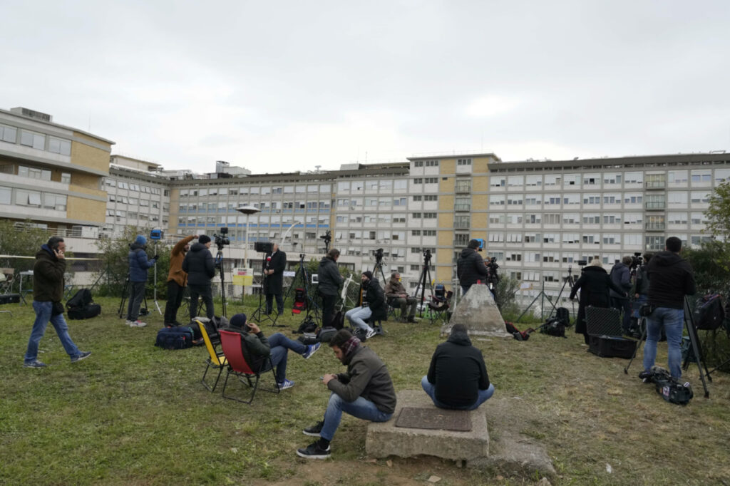 Members of the media set up their gear outside the Agostino Gemelli hospital under the rooms on the top floor normally used when a pope is hospitalised, in Rome, on Friday, 31st March, 2023