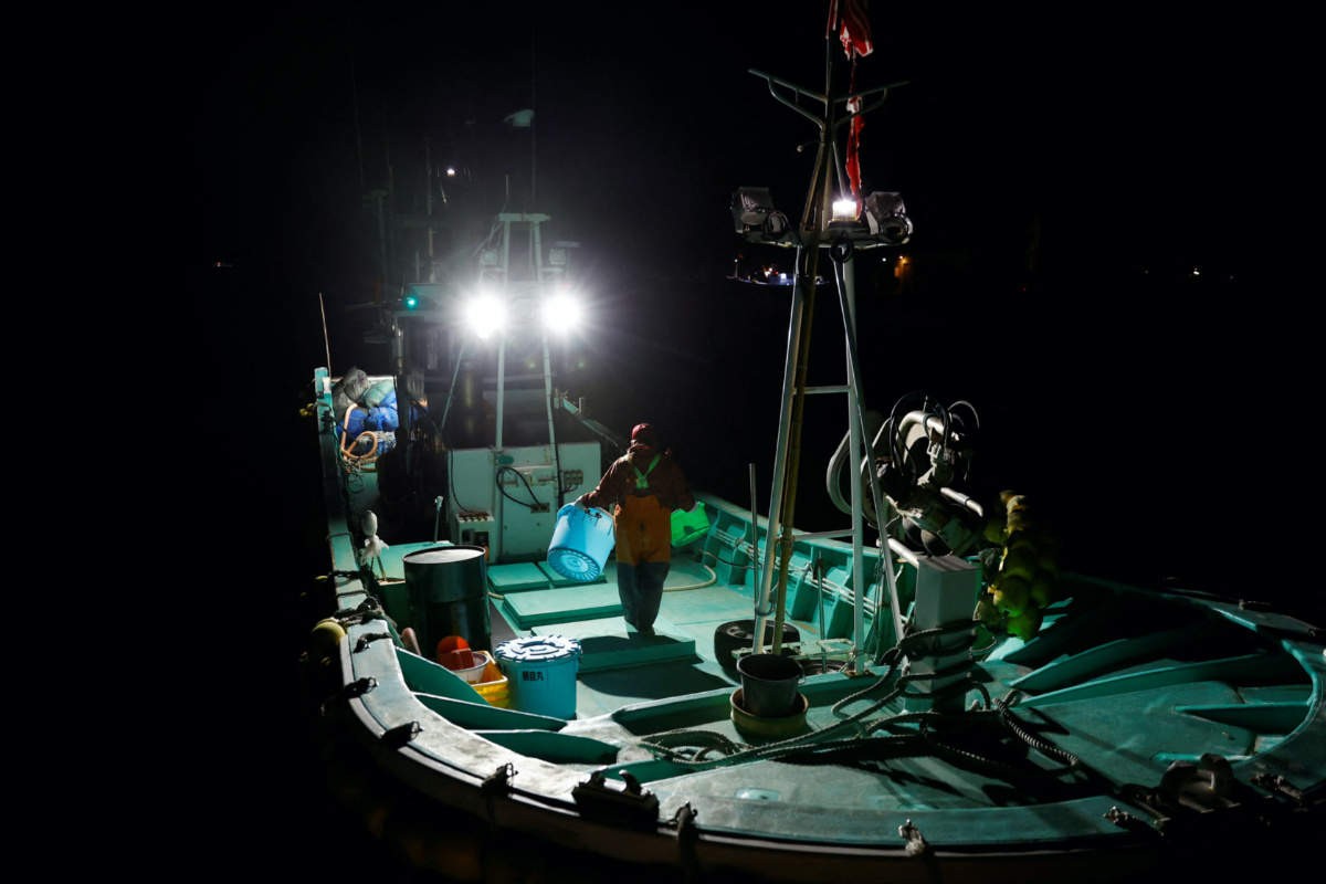 Fisherman Haruo Ono, 71, stands on his boat before going to work at sea for the night, at Tsurishihama fishing port in Shinchimachi, about 55 km away from the disabled Fukushima Dai-ichi nuclear power plant, in Fukushima Prefecture, Japan, March 1, 2023. 