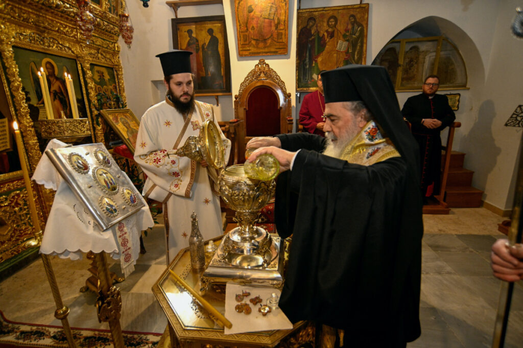 Greek Orthodox Patriarch of Jerusalem Theophilos III mixes the oils from the Mount of Olives to make Chrism Oil, which will be used in the coronation of Britain's King Charles on May 6, in Jerusalem, March 3, 2023.