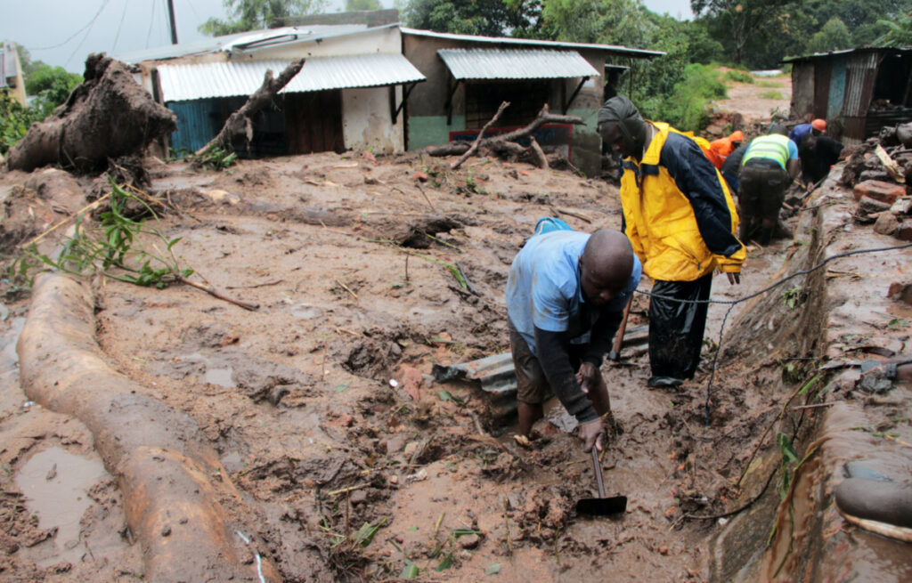 Men dig in search of survivors and victims in the mud and debris left by Cyclone Freddy in Chilobwe, Blantyre, Malawi, March 13, 2023. REUTERS/Eldson Chagara.