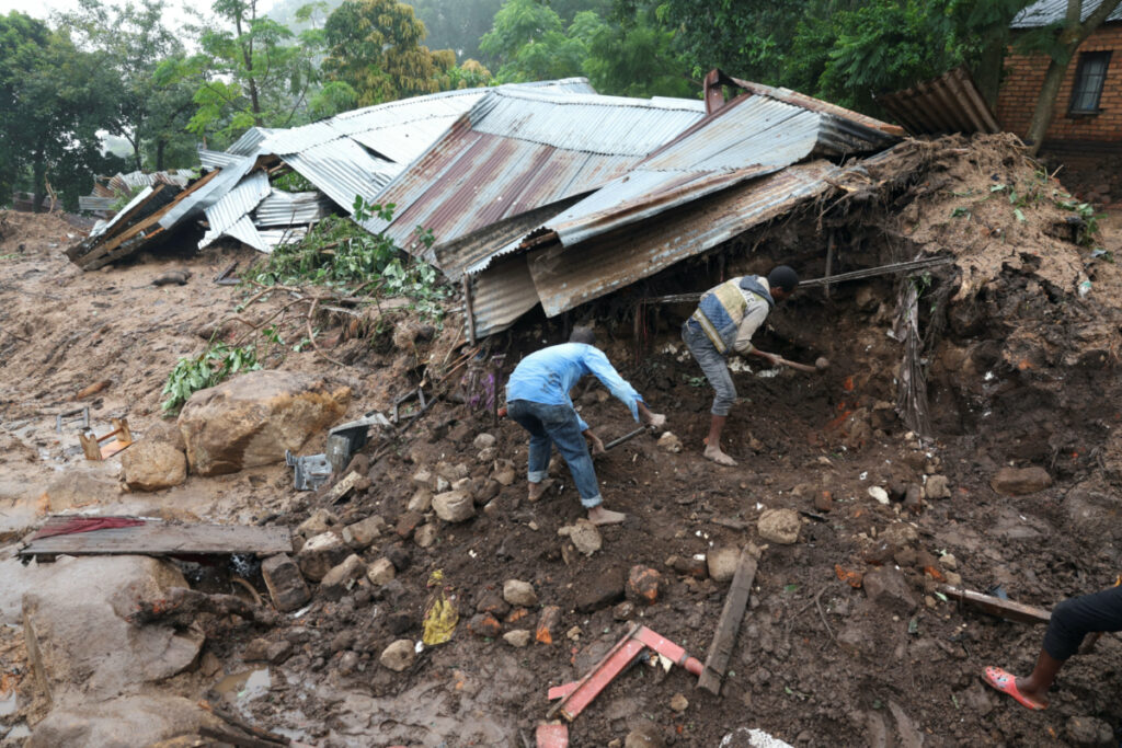 People dig for their belongings after their home was destroyed during a landslide in Chilobwe, Blantyre, Malawi, on 17th March, 2023.