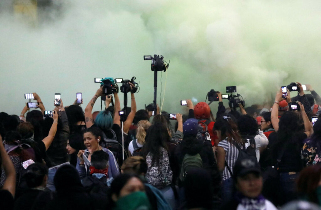FILE PHOTO: Members of the media work amid a cloud of tear gas during a protest against gender-based violence in downtown of Mexico City, Mexico, February 14, 2020. REUTERS/Carlos Jasso