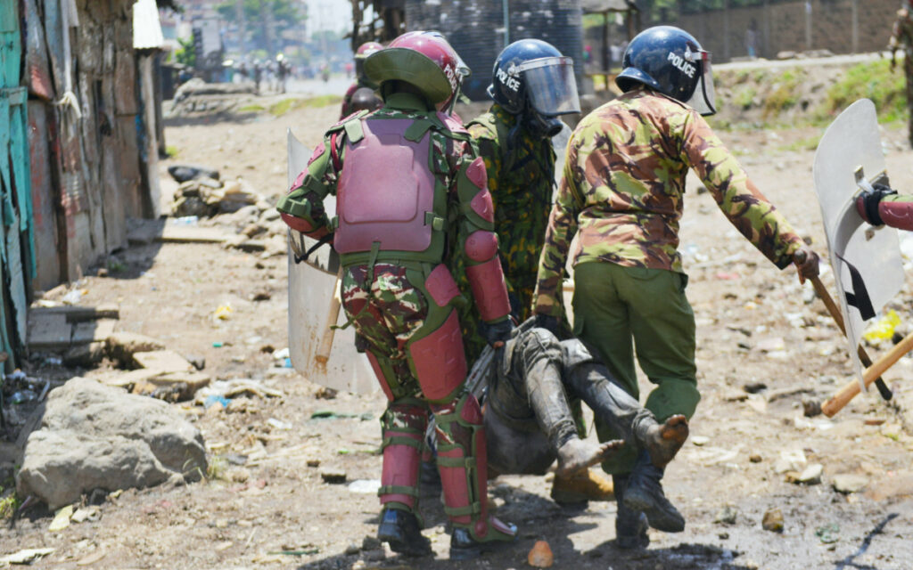 Riot police officers detain a supporter of Kenya's opposition leader Raila Odinga of the Azimio La Umoja (Declaration of Unity) One Kenya Alliance, as they participate in a nationwide protest over cost of living and President William Ruto's government in Mathare settlement in Nairobi, Kenya March 27, 2023. REUTERS/John Muchucha