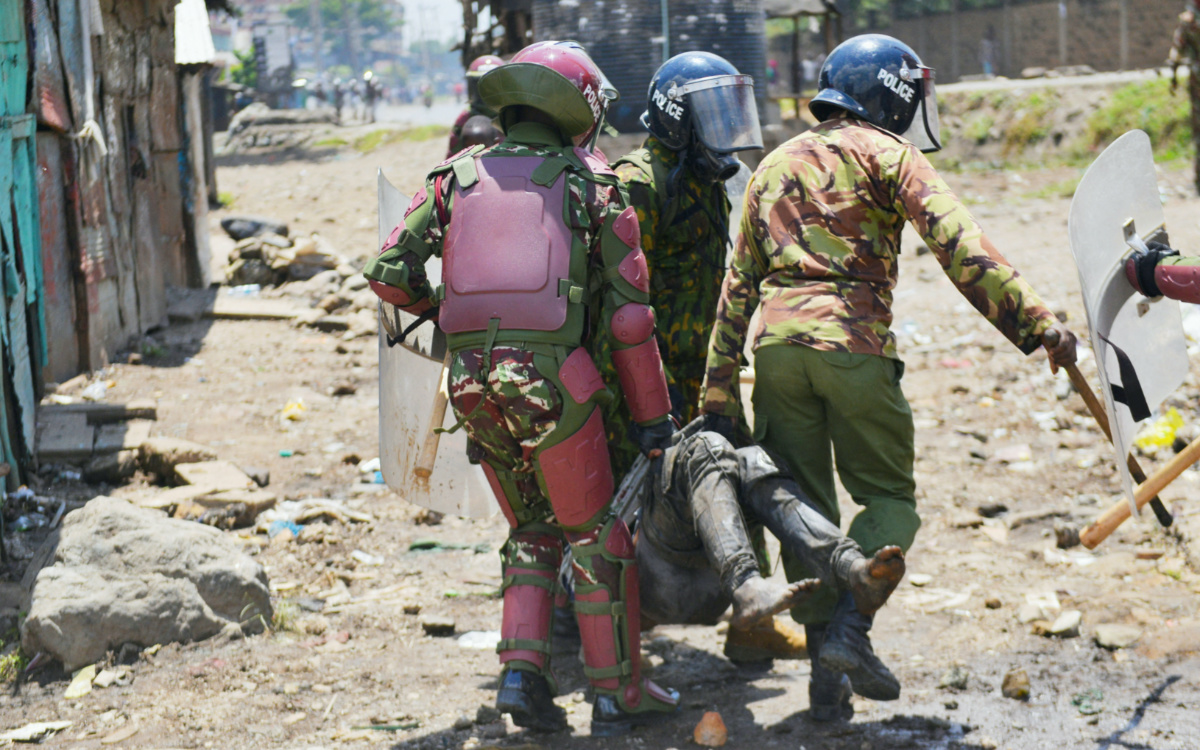 Riot police officers detain a supporter of Kenya's opposition leader Raila Odinga of the Azimio La Umoja (Declaration of Unity) One Kenya Alliance, as they participate in a nationwide protest over cost of living and President William Ruto's government in Mathare settlement in Nairobi, Kenya March 27, 2023. REUTERS/John Muchucha