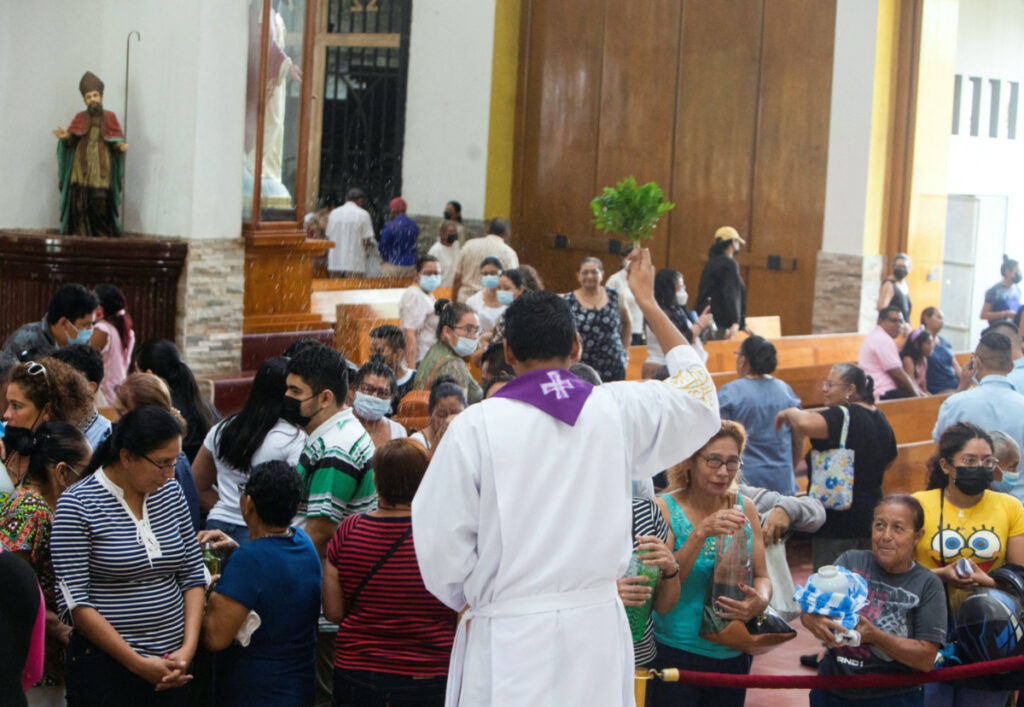 A bishop sprinkles water on the catholic parishioners at the Metropolitan Cathedral, as a suspension of diplomatic ties between Nicaragua and the Vatican has been proposed according to a Nicaragua's foreign ministry statement, in Managua, Nicaragua March 12, 2023. REUTERS/Stringer