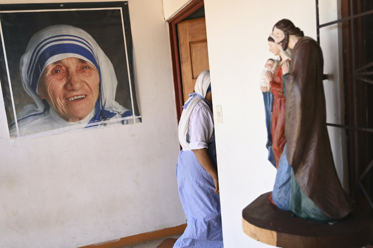 A sister of the Missionaries of Charity order, who is one of the 18 nuns expelled last year from Nicaragua, walks past a poster of St Teresa of Calcutta, in a parish home in Las Canas, Costa Rica, Wednesday, March 1, 2023. 