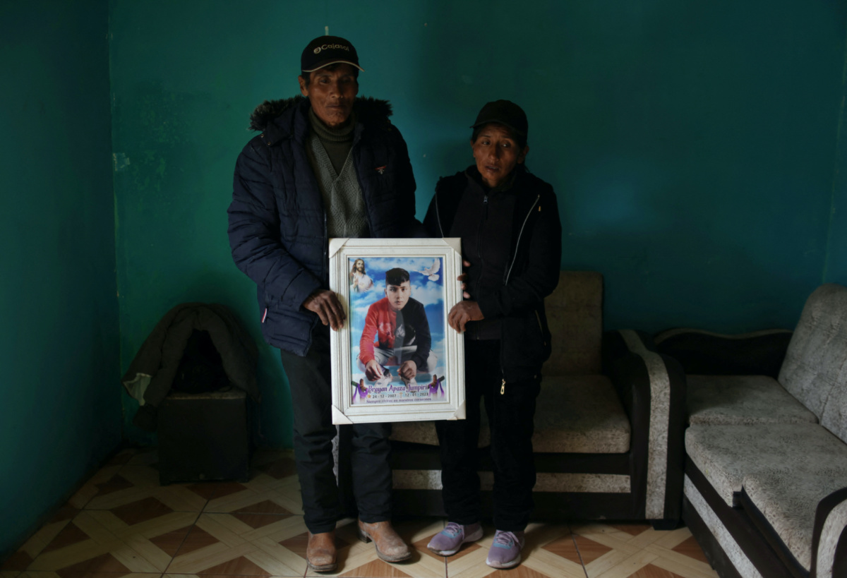 Asunta Jumpiri, 38, and her husband Alfredo Apaza, 60, hold a photo of their 15-years-old son Brayan Apaza Jumpiri, one of the victims killed during latest protests against Peru's President Dina Boluarte, at their home in Juliaca, in Puno region, Peru February 7, 2023. 