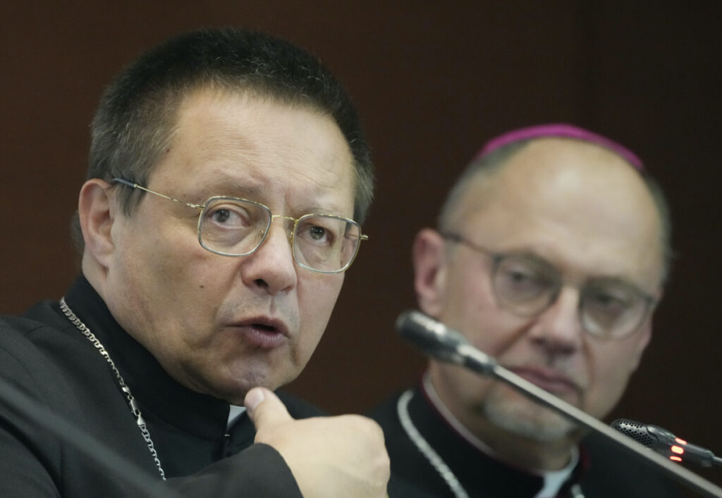Poland's Archbishop Grzegorz Rys, left, meets the media on Tuesday, 14 March 2023.
