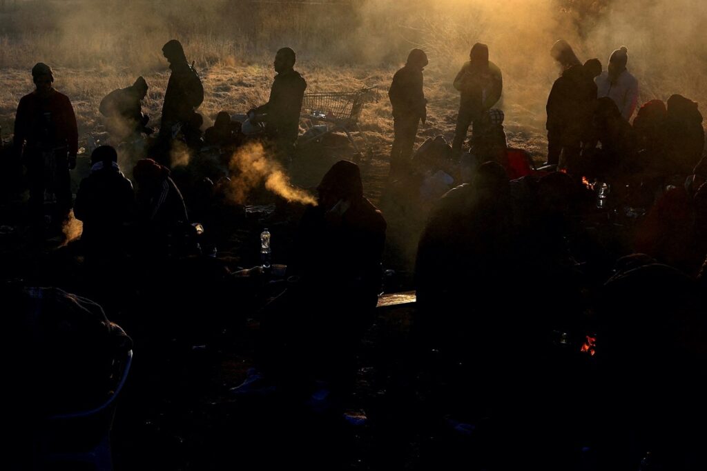 Refugees brave the cold in a frozen field after they fled from Ukraine because of the Russian invasion at the border checkpoint in Medyka, Poland, March 1, 2022.